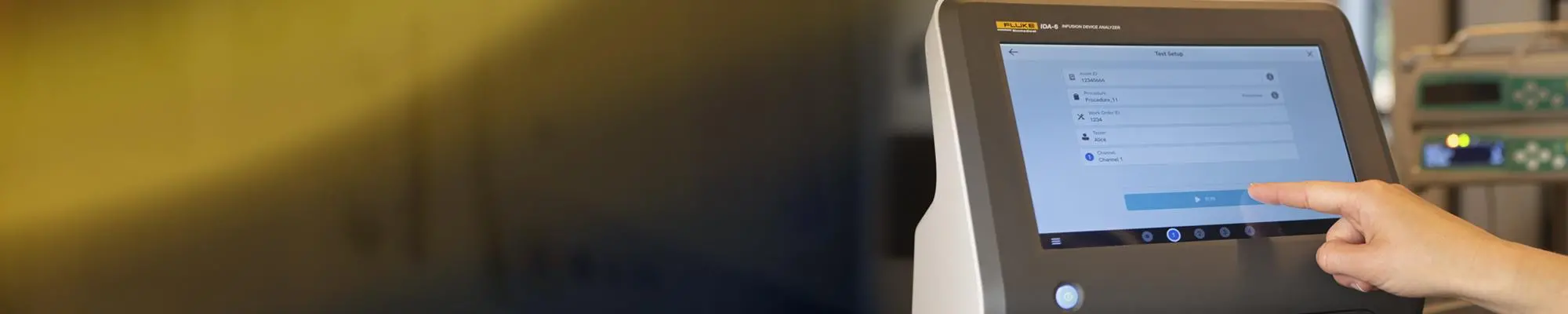 Person interacting with IDA-6 Infusion Device Analyzer touchscreen